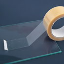 Clear glass protection tape being applied to a glass surface with a blue background