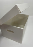 An open white polypropylene file box with a hinged lid and cut out handles, flat packed and ready for assembly.